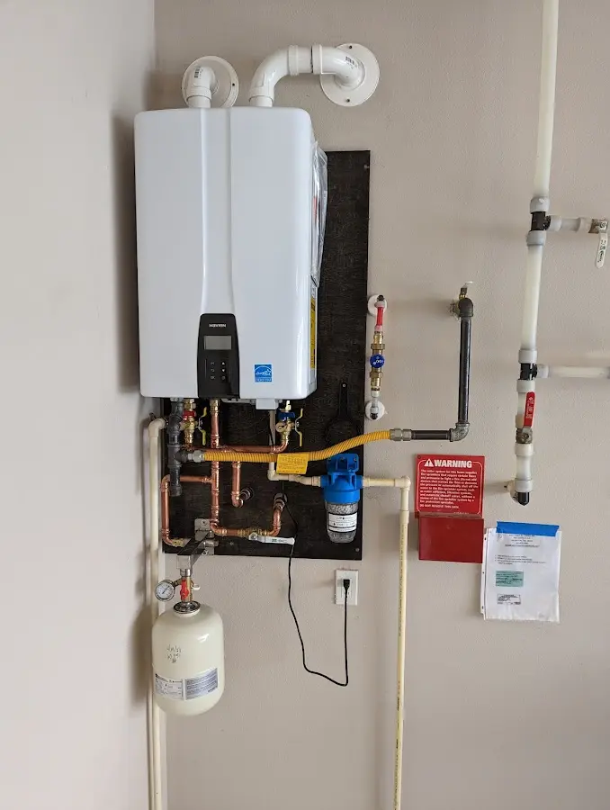 Professional plumber installing copper piping in a Saddle River home